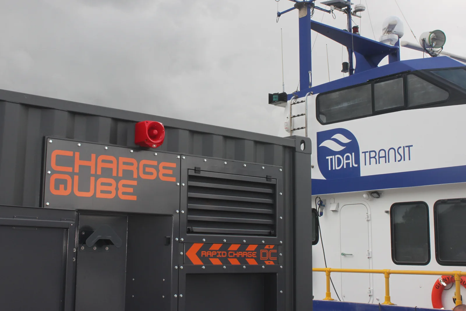 Close view of the CQ450 rapid charge DC panel, with the white and blue hull of a Tidal Transit vessel behind